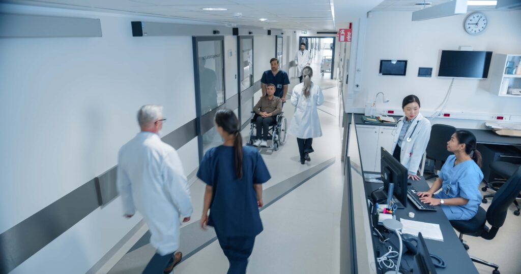 Typical hospital corridor with doctors, nurses and staff