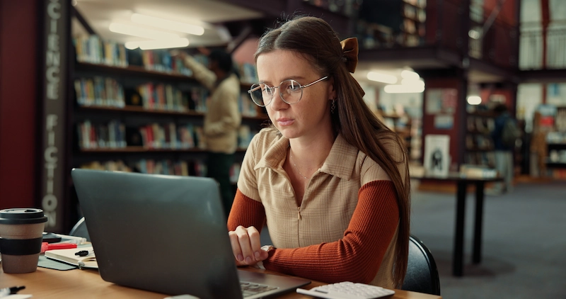 Lift maintenance at Durham University. Female student studying on laptop